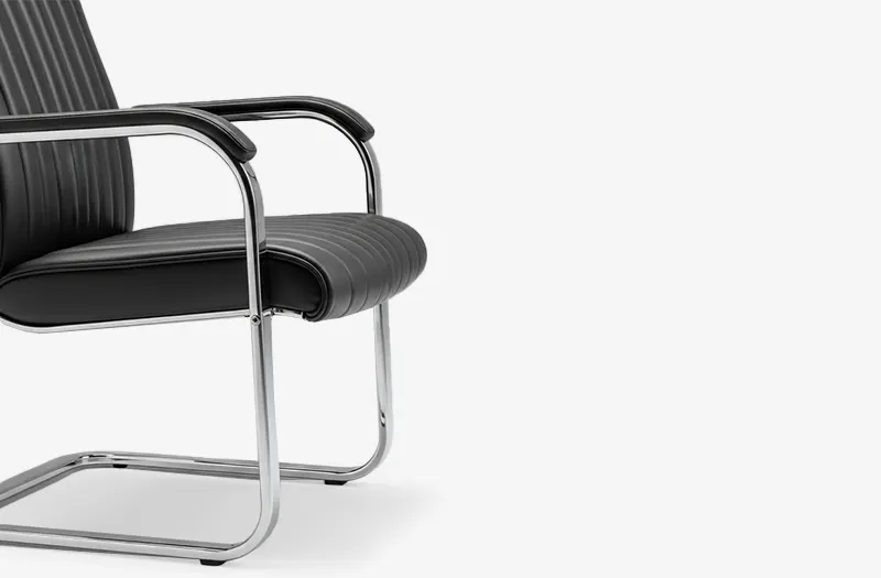 Modern guest chair with C-base and dark brown leather seat – side view