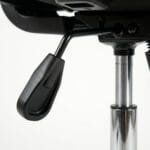 Side view of a black ergonomic mesh office chair featuring an adjustable headrest, lumbar support, comfortable armrests, and a rolling caster base.